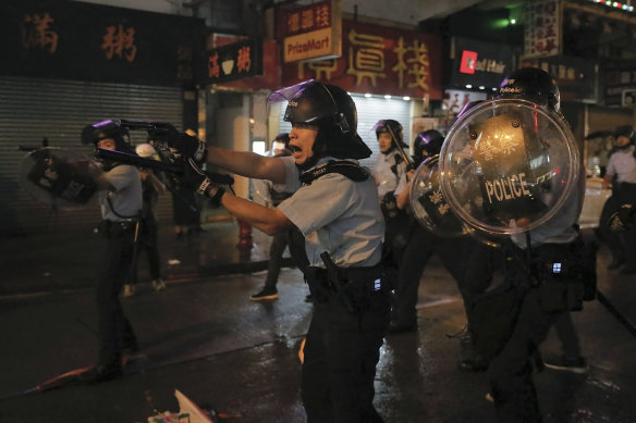 Hong Kong police drew weapons and rolled out water cannon trucks for the first time on Sunday night.