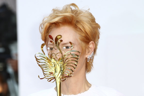 Actress Tilda Swinton holds a carnival mask on arrival at the opening ceremony of the 77th Venice Film Festival last year.
