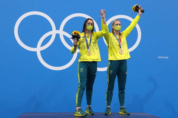 Kaylee McKeown and Emily Seebohm on the top of the medal dias after McKeown won gold in the 200m backstroke.
