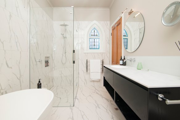 The spacious bathroom, complete with a stained-glass window.