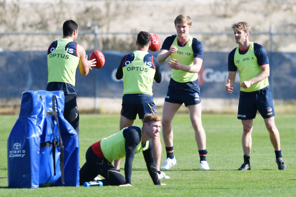 Rory Sloane, right, trains with teammates. 