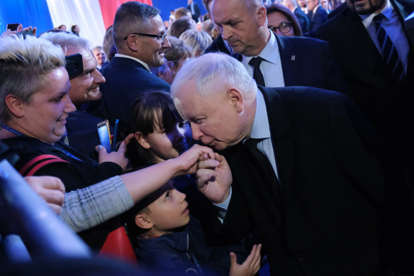 Jaroslaw Kaczynski, leader of the right-wing Law and Justice (PiS) political party, greets supporters at an election rally on the last day of campaigning.