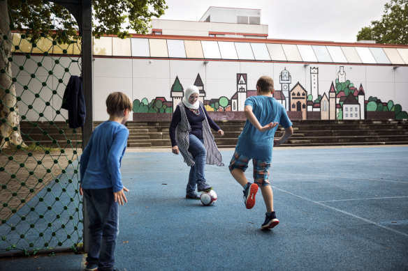 Noura Baterdouk, a 38-year-old mother of three from Syria, plays soccer with two of her sons in Tettnang, Germany.