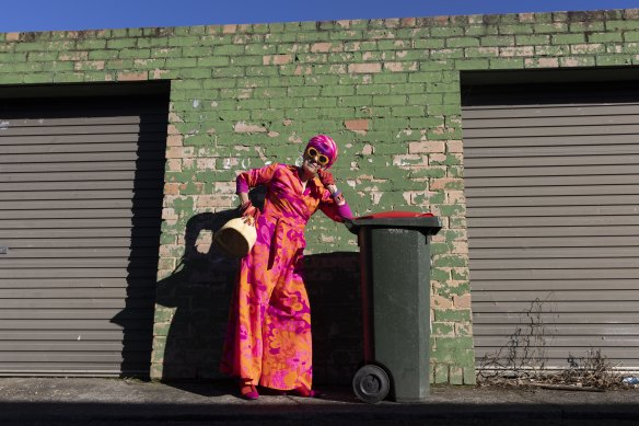 Linda, dressed appropriately as always, posing with one of her trusty bins.