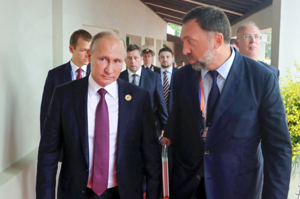 Russian President Vladimir Putin, left, and Russian metals magnate Oleg Deripaska, right.