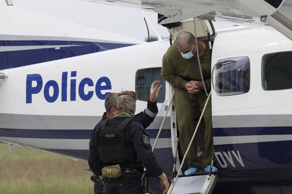 Mostafa Baluch arrives via police escort at Bankstown airport on Thursday night.