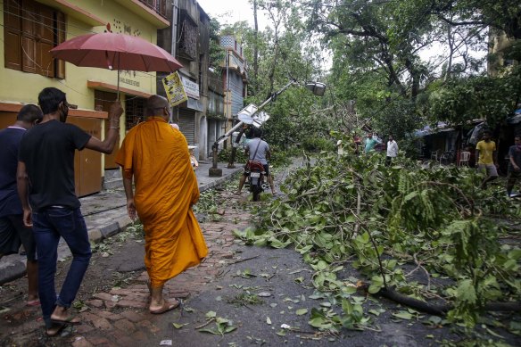 A Buddhist monk walks through a Kolkata road after Cyclone Amphan hit the city overnight on Wednesday May 20. 
