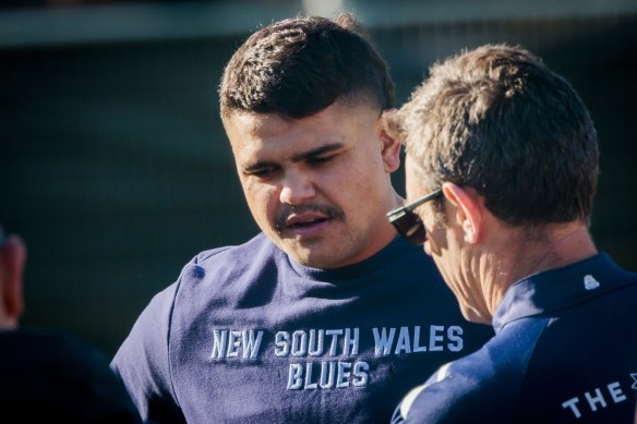 Brad Fittler talks to Latrell Mitchell during training.