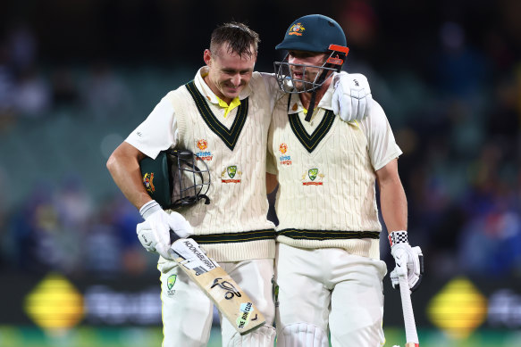 Twin tons: Marnus Labuschagne and Travis Head walk off the field at stumps.