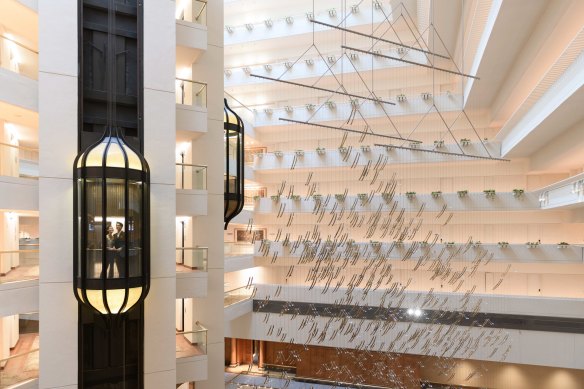 Glass elevators run stealthily up and down in the Conrad Singapore Orchard’s atrium next to the glittery sculpture, Singapore Shower, by Japanese kinetic sculptor Michio Ihara