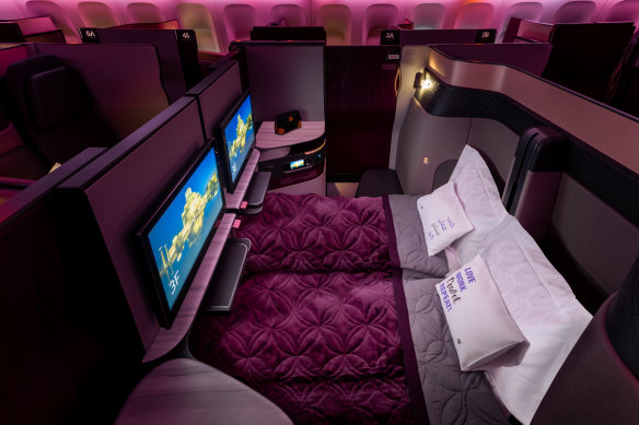 Qsuite converts to a lie-flat bed, with options for couples to remove centre-seat privacy screens.