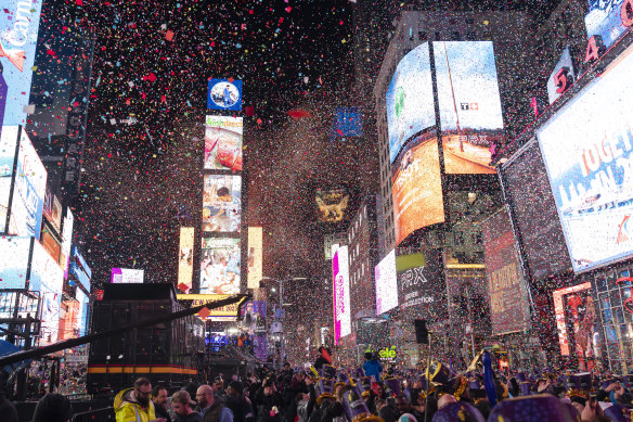 Confetti falls at midnight on Sunday, January 1 during the New Year celebration in Times Square.
