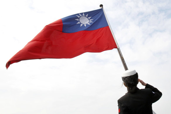 A Taiwanese military officer salutes the Taiwanese flag.