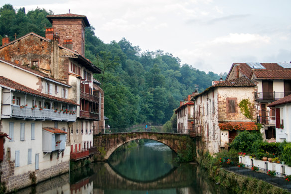 Walking across a bridge in Saint-Jean-Pied-de-Port, France. 