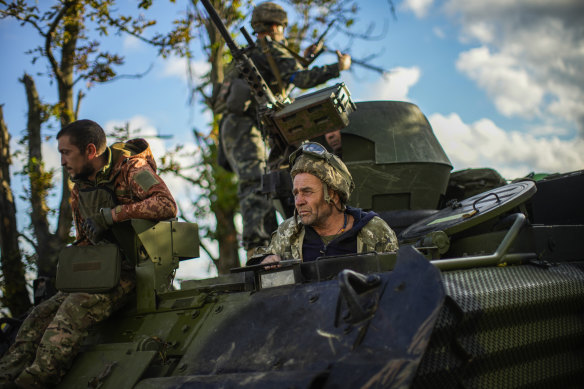 Ukrainian soldiers drive an armoured vehicle in Shandrygolovo village, near Lyman, Ukraine.