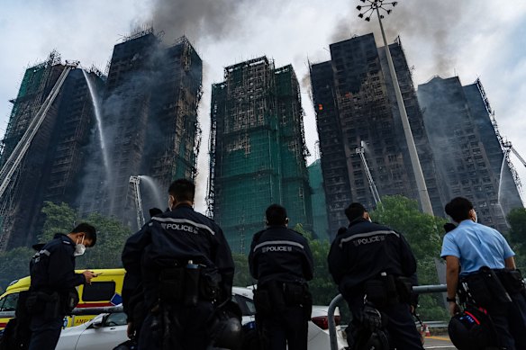 Firefighters work to extinguish the fire at Wang Fuk Court, where hundreds of people are unaccounted for.