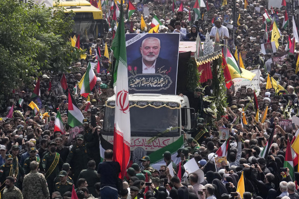 Iranians follow a truck carrying the coffins of Hamas leader Ismail Haniyeh and his bodyguard, who were killed in an assassination blamed on Israel.