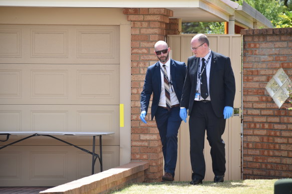 Detectives leave the Sunningdale Circle property on Monday afternoon as the investigation continues.
