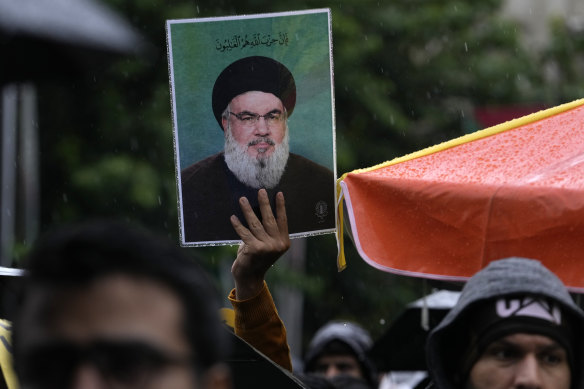 An Iranian demonstrator holds up a poster of the leader of Lebanon’s militant Hezbollah group Hassan Nasrallah.