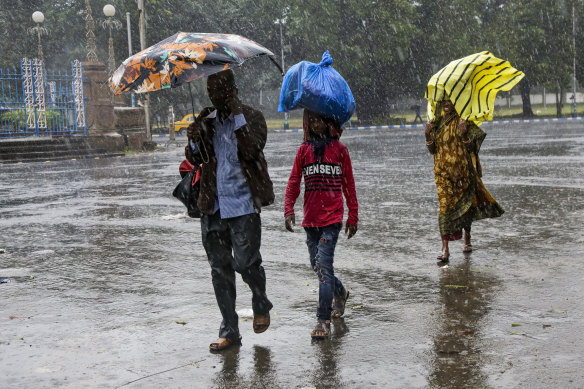 Heavy rains from the cyclone hit Kolkata, India, on Saturday.