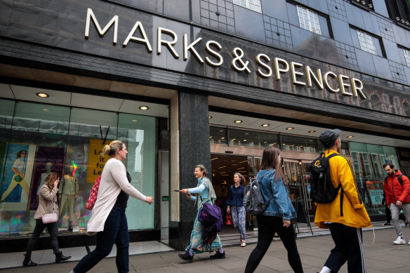 Shoppers walk past a Marks & Spencer store on Oxford Street. 