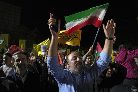 Demonstrators cheer as they wave Iranian and other flags in an anti-Israel gathering in Tehran, celebrating Iran’s missile strikes on Tel Aviv and other Israeli sites.