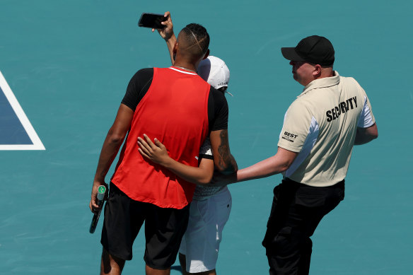 A spectator ran on court to take a selfie with Kyrgios.