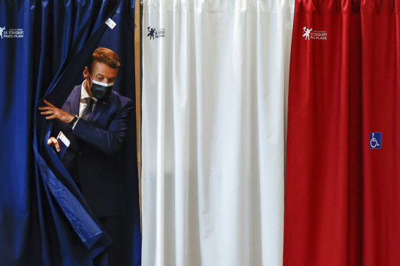 French President Emmanuel Macron leaves the voting booth during the first round of French regional and departmental elections, in Le Touquet-Paris-Plage, northern France on Sunday.