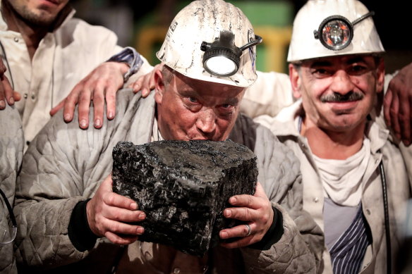 Miners kiss the last piece of coal during a farewell event for the German hard coal mining industry in 2018.