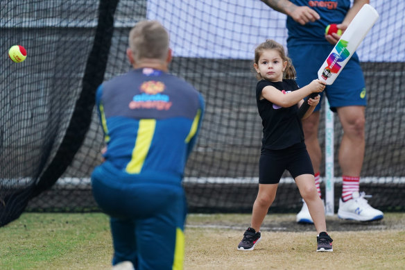David Warner plays cricket with daughter Indi Rae during an Australia cricket team training session at the MCG in on Christmas Day.