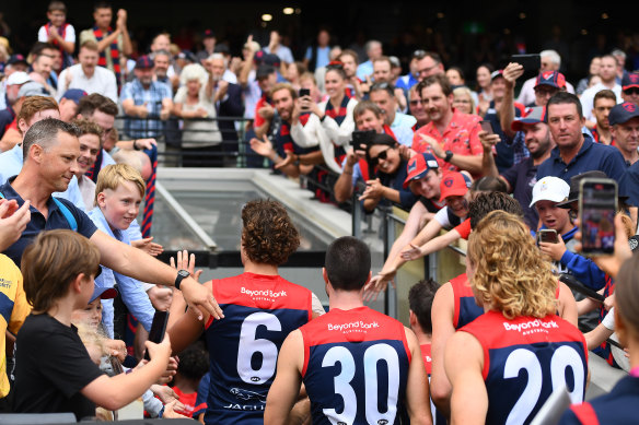 Demons fans show their appreciation after Melbourne’s win against Fremantle on Saturday.