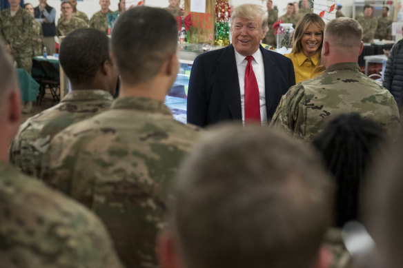 Donald Trump speaks during a visit to one of the targeted airbases - the Ain Asad airbase - in December 2018.