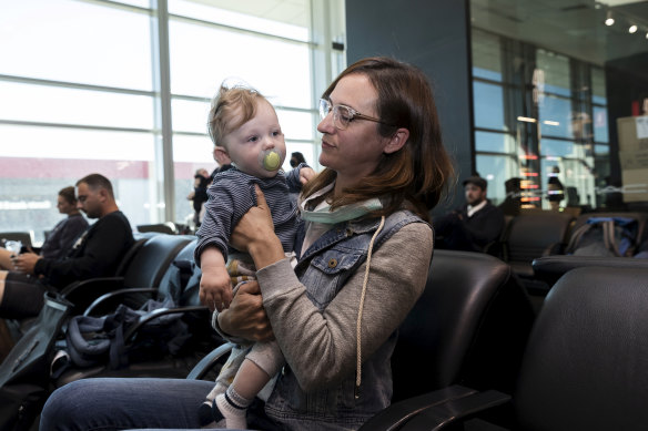 Nina Lacy and her eight-month-old son, Luca, have flown to meet her husband's family in Adelaide. 