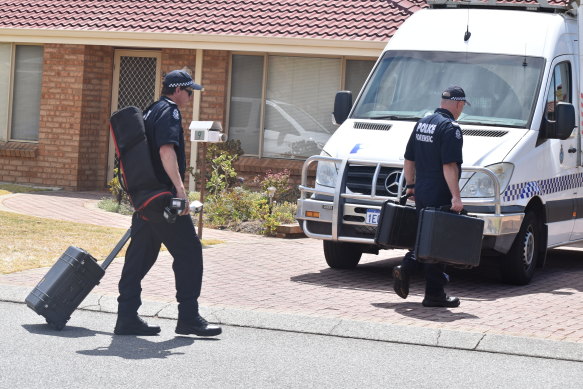 Forensics carrying evidence investigation equipment into the property on Monday.