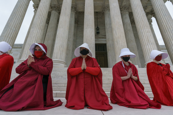 Activists opposed to the confirmation of US Supreme Court nominee, Judge Amy Coney Barrett, dressed as characters from 'The Handmaid's Tale' outside the court on Sunday, ahead of confirmation hearings.