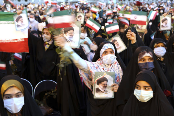 Supporters of Iranian president-elect Ebrahim Raisi celebrate after his presidential election win. 