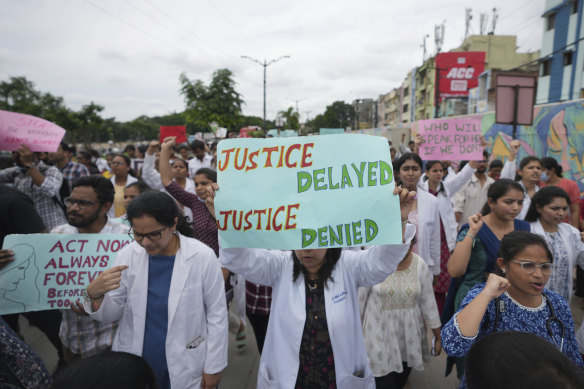 Doctors protesting against the alleged rape and killing of a trainee doctor at a government hospital in Kolkata, hold placards during a protest rally in Hyderabad, India, on Thursday.
