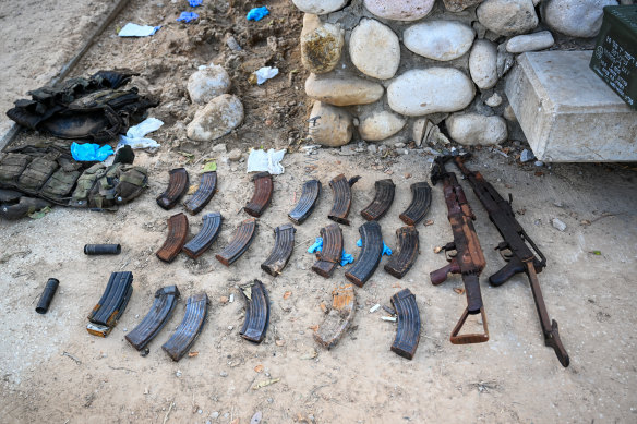 Automatic weapons, magazines, and flak jackets are displayed after Hamas militants attacked this kibbutz days earlier near the border of Gaza in Kfar Aza, Israel.