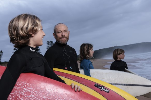 Australian former professional surfer Tom Carroll with grommets he teaches every Friday morning.