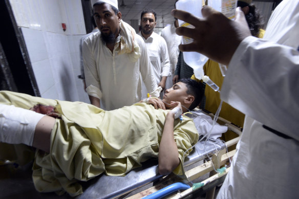 Relatives transport an injured victim of a powerful bomb upon arrival at a hospital in Peshawar, Pakistan.