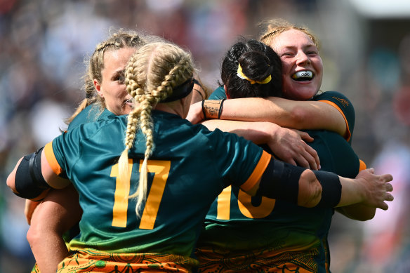 Grace Kemp and the Wallaroos celebrate victory over Wales at the World Cup.