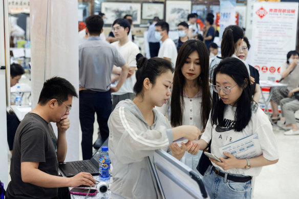 Young people attend a job fair at a Beijing shopping centre. Youth unemployment is at a high in China.