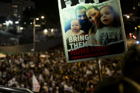 A protester holds a sign with a picture of the kidnapped Bibas family during a demonstration in Tel Aviv last month.