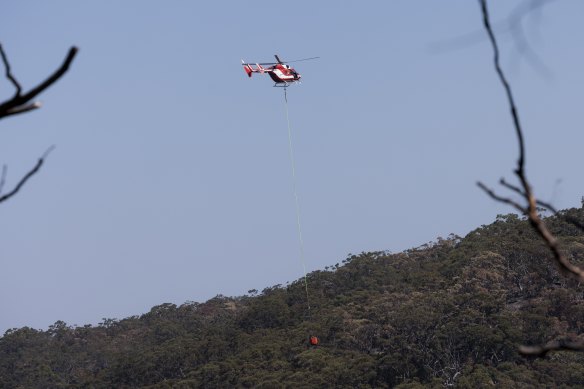 A chopper looks for spot fires around  Charlton Creek. 