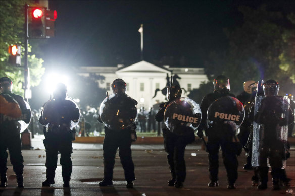 Police form a line on H Street as demonstrators gather to protest the death of George Floyd.