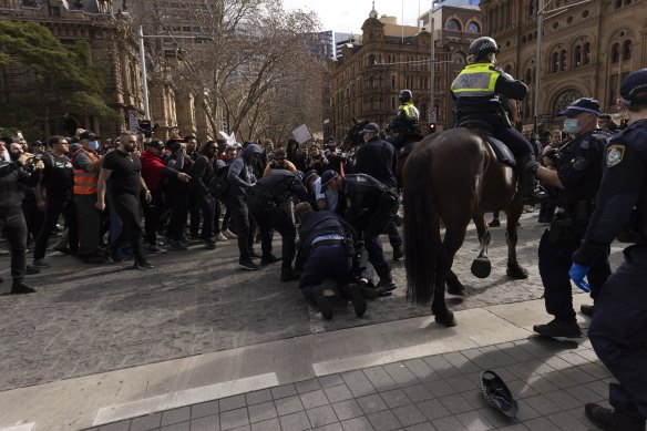 Police charged 57 people and issued 90 fines after crowds clashed with dozens of officers as demonstrations converged on major cities across Australia on Saturday.