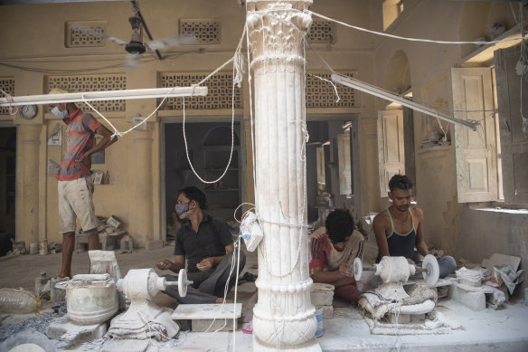 Craftsmen work at a marble inlay factory in Agra, India, June 24, 2021. The scarcity of visitors is a problem not only for Agra but also for the Archaeological Survey of India, the government agency that uses its share of the ticket sales to the Taj Mahal to restore and maintain many of the 3500 lesser-known but historically significant monuments from India’s long, epic history. 