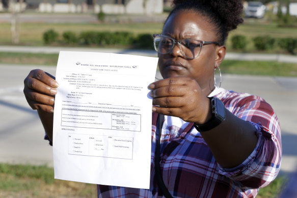 Darresha George shows the unsigned suspension form her son Darryl received on his return to school.