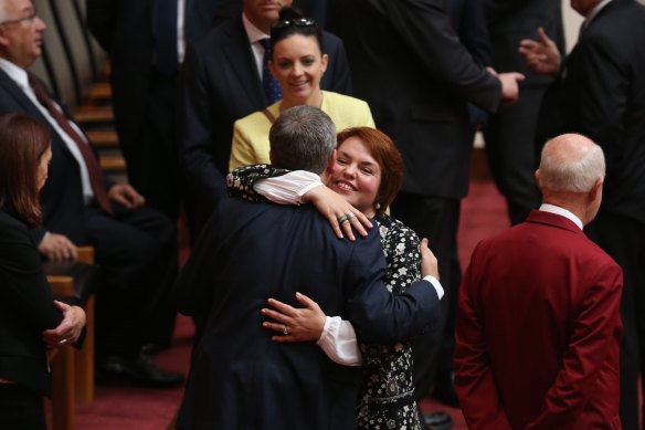 Senator Kimberley Kitching is embraced by then-opposition leader Bill Shorten after her first speech in the Senate at Parliament House in 2016. 