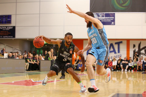Wing and a prayer: Phoenix's John Roberson comes up against some long-limbed opposition against the Breakers.